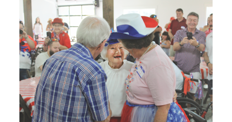Emma 'Queen' Jean Jarrard Miller, center, is greeted by friends during her centenary birthday celebration at Wimpy Farms in Dahlonega. Jarrard turned 100 on July 4, as the nation celebrated its 250th birthday.