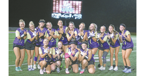The Lady Indians celebrate the varsity flag football team’s first-ever victory.