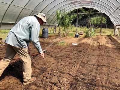 Daniela Cintron/ Chuck Mashburn works the soil
