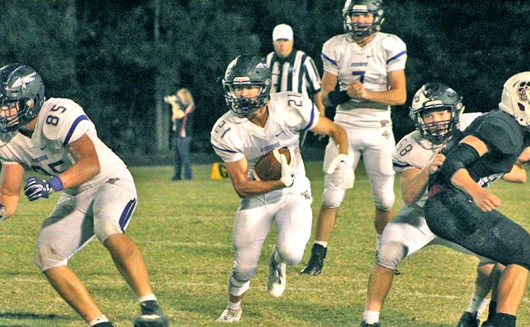 LCHS running back Tanner Barber utilizes some blocking to pick up some hard fought for yards in the Indians’ 31-0 loss to Jackson County.