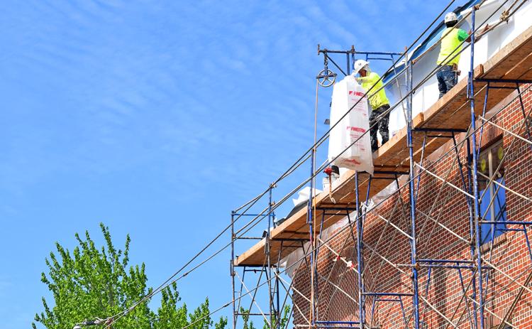 Though regular business has slowed to a halt on the square, construction has continued at a steady pace at the downtown hotel emerging on East Main Street. (photo by Matt Aiken)