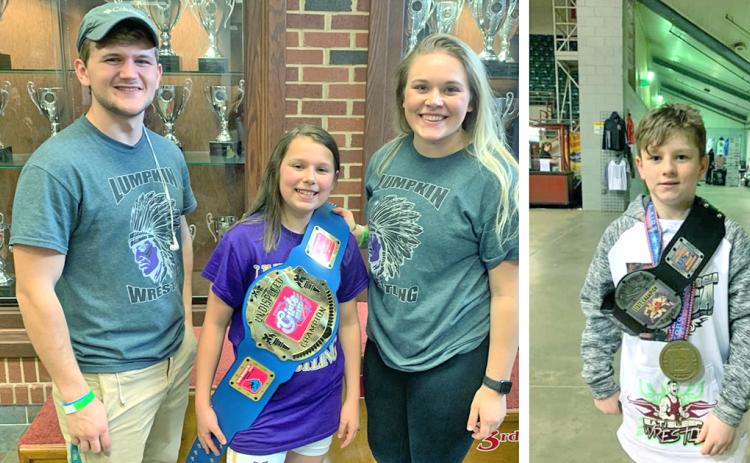 LEFT: Caroline Cunningham celebrates her State Championship title with Lumpkin County Youth Wrestling Club coach Tristin Duckworth and her wrestling idol Kaylee Seabolt.  RIGHT: Caleb Yorkey shows off his State Champion belt and medal after an overtime win in the finals. Yorkey became the first USA wrestling champion for Lumpkin County in years.