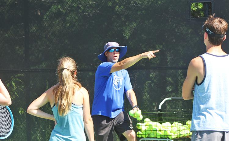 UNG head tennis coach gives instructions for a drill to campers of the UNG tennis camp last week.