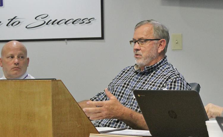 Superintendent Dr. Rob Brown (left) and board member Jim McClure speak at the Board of Education meeting on Monday.