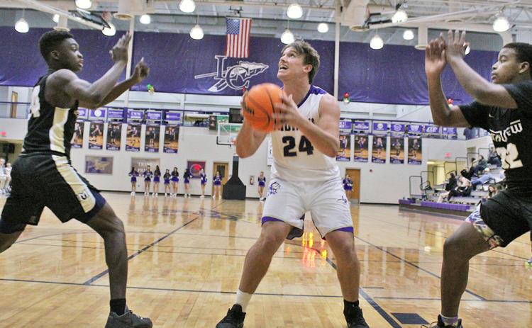 Senior Drew Allison takes a pass down low and looks to put up a shot during the Indians’ first game of the Kelly King Holiday Classic on Monday, December 21 against Mountain View High School. Both teams Lumpkin faced in the tournament challenged them with size and physical presence near the basket, something the Indians haven’t faced very much in the first half of the season.