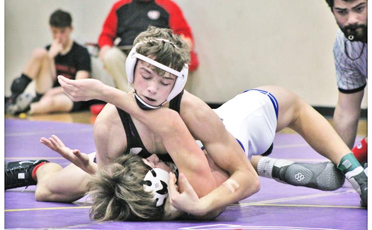 Jack Irwin, the lone returning state placer for Lumpkin, finishes off his opponent with a pin to claim third place in the 145 lb. weight class at the John Smith Invitational Wrestling Tournament held at LCHS on Friday and Saturday.