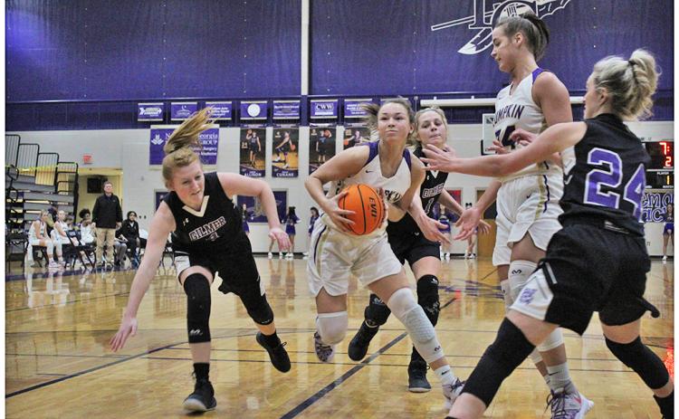Freshman Averie Jones weaves through a host of defenders toward the hoop for a basket against Gilmer County on Friday. As the team’s leading scorer on the season, Jones adds versatility to an already lethal attack that head coach David Dowse only sees getting better.