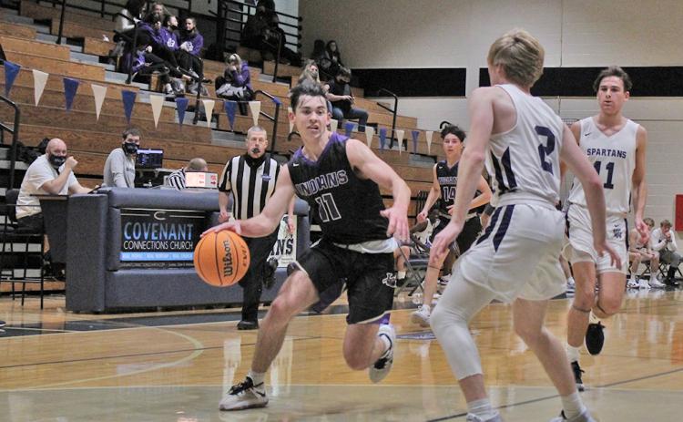 Junior guard Jones Harris drives past a defender toward the basket in the second half of the Indians’ game against West Hall. Harris tied for a game-high 16 points in the crucial region-win.