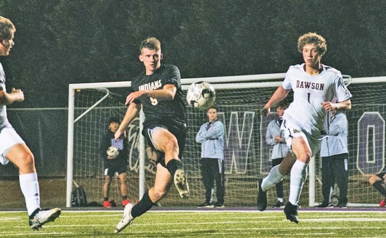 Senior Dylan Bodney sends the ball between multiple Dawson County defenders on the attacking end during the team’s Senior Night victory over the Tigers. Bodney scored one of three goals.