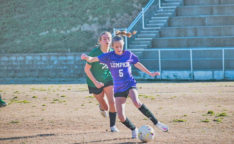 Middle school player Kaitlyn Johnson controls the ball and looks to create a play out wide.