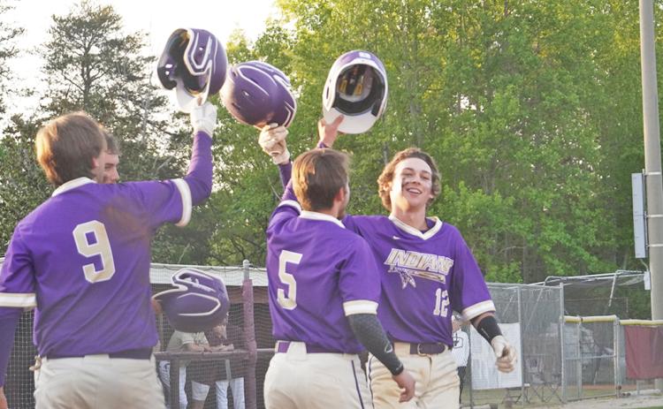 Hunter Cooper (right) celebrates with his teammates after hitting a three-run home run in Lumpkin’s season finale against Dawson County on April 23.