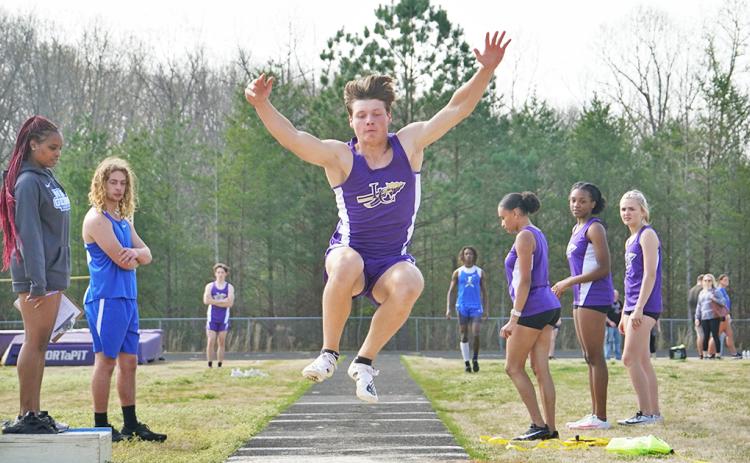 Lumpkin County sophomore Caleb Norrell flies through the air attempting to cover as much distance as possible during the Long Jump event.