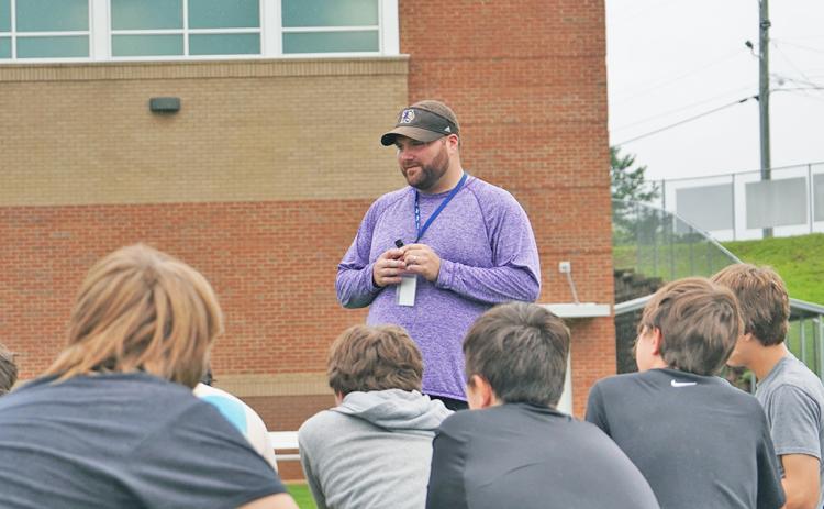 LCMS head coach Hayden Grizzle addresses his team after a recent summer workout. Having worked at both the middle school and high school level, Grizzle said he enjoys coaching the middle school age players the most because he feels he can have a larger positive impact in their lives.