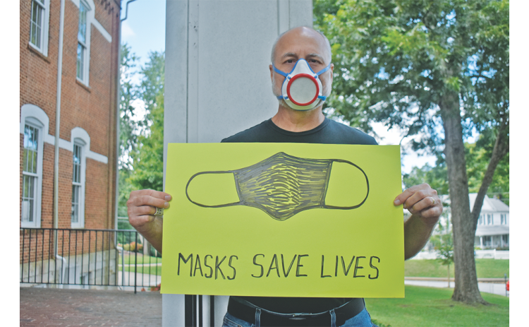 Art professor Jon Mehlferber, is wearing the mask he 3D printed hundreds of last spring.