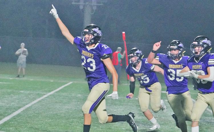 Preston Cox and his defensive teammates run off the field in celebration after Cox made the game-saving tackle on fourth down to give the Indians their second win of the season.