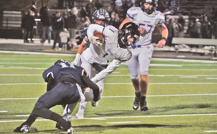 Lumpkin freshman Cal Faulkner lunges forward for extra yards as he’s tackled during the Indians’ final game of the season at West Hall.