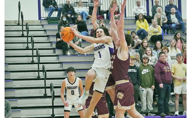 Freshman Cal Faulkner takes on the contact and drives to the basket against two Dawson defenders during Tuesday’s win over the Tigers. Lumpkin notched its first win over their rivals in five years behind a second-half takeover by Faulkner, who scored 15 of his 23 points in the second-half.