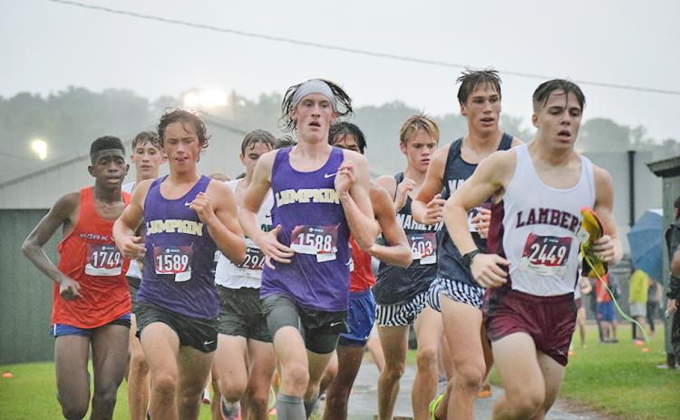 Lumpkin County High School runners, Wyatt Windham, left, and Ben Sherrill pushed through the sloppy conditions to finish with new personal records at the weekend meet in Pickens County.
