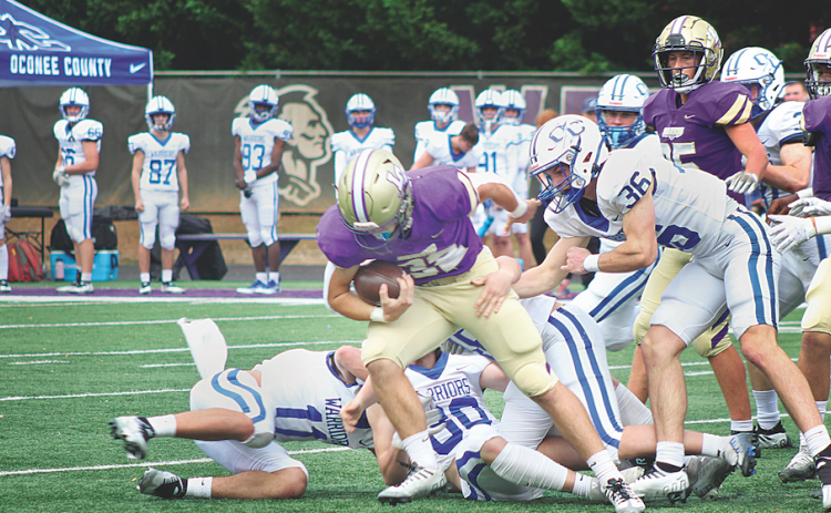 LCHS junior fullback Mason Sullens powers ahead against the Oconee County defense in the Indians Class AAA playoff game on Saturday.