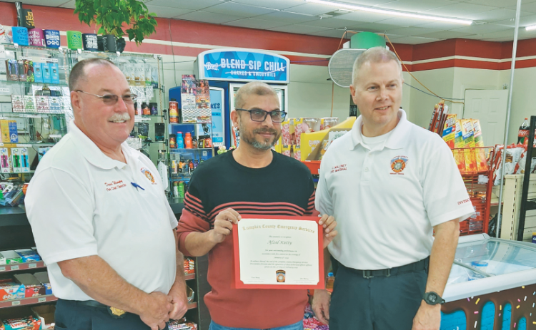 Afzal Kutty of the local “Disco” Marathon gas station was recently recognized by Lumpkin County Fire Chief David Wimpy (left) and Fire Marshal Chris Maloney. Kutty acted quickly on the night of January 15 to extinguish a blaze that occurred after a driver of a Jeep lost control and collided with the gas pump.
