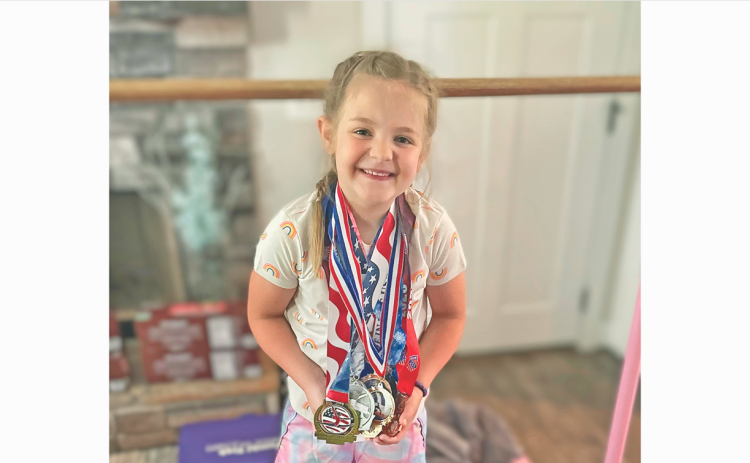 Lumpkin gymnast Jenna Watkins shows off the medals she earned at the State Championship meet.