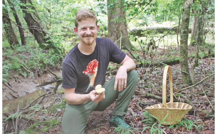 Certified mushroom identification expert and Mindfull Mycology owner Sam Blackstone shows off a wild mushroom he spotted while foraging on his 40-acre property just outside of Dahlonega.