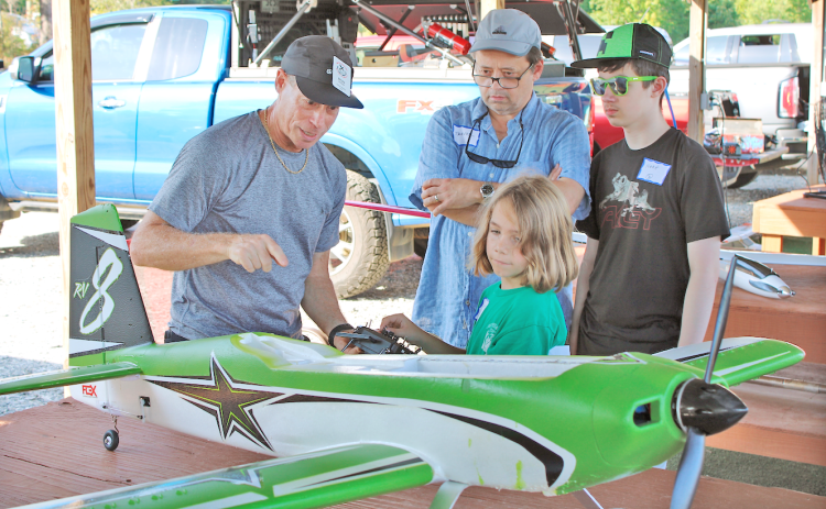NGMA member Ron Gaynor explains the basics of lift, weight, drag and thrust to Judah Payne, 7, Noah Wade, 14, and Trevor Wade during the club’s recent Junior Flight Academy event.