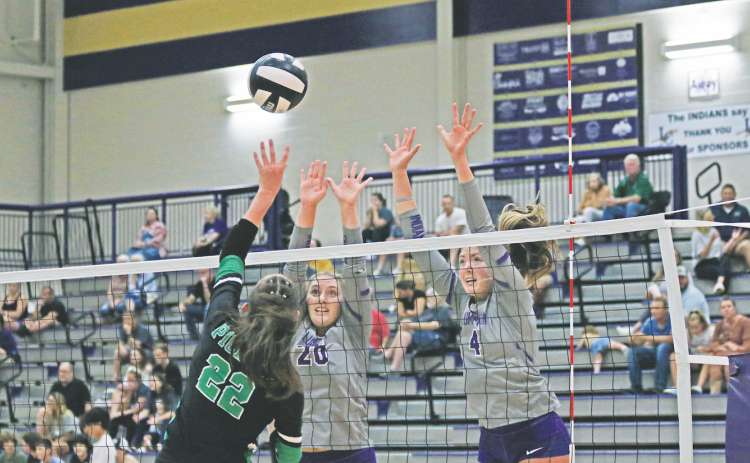 Morgan Powell, right, and Mary Richardson attempt to make a block at the net.