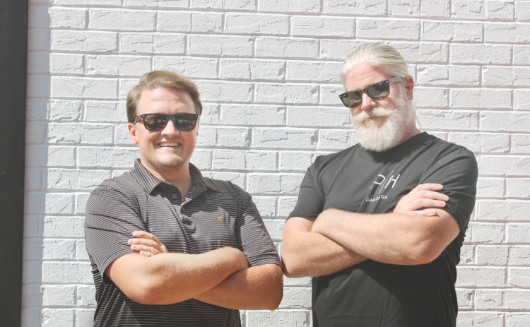 New restauranteurs Ryan Reagin, left, and Tracy Huggins take a quick break from their busy day on the outdoor patio of the new Public House Kitchen & Cocktails.