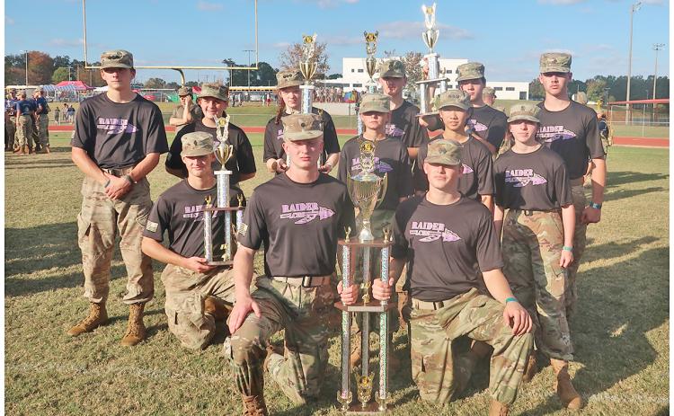 The Lumpkin County Raiders team shows off their new hard-earned championship trophies.