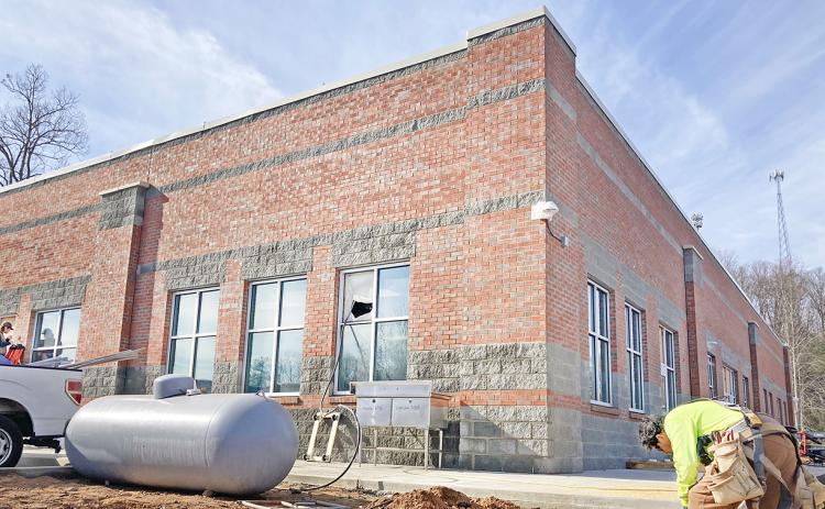A construction worker labors outside the new Lumpkin County College & Career Academy building on the LCHS campus.