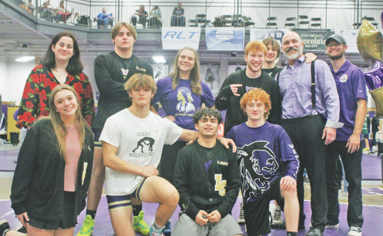 Head Coach Sean Hage and Coach Cale Goss gather with the Lumpkin wrestling seniors.