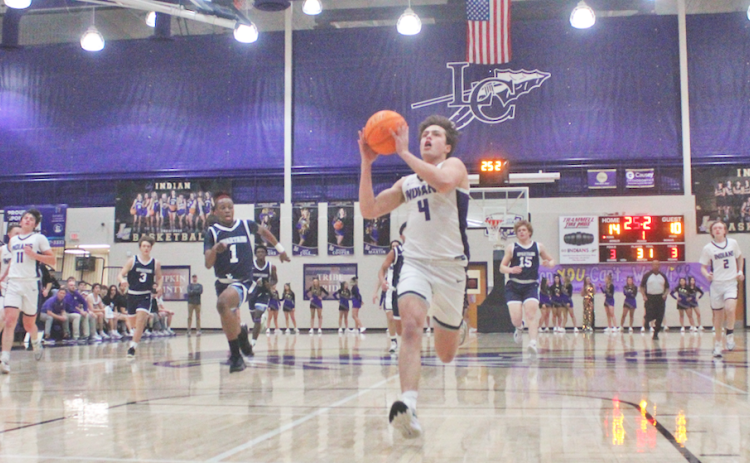 Lumpkin County’s Walker Scott races down the court for a breakaway layup.