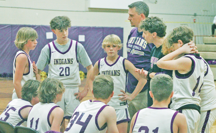 The Lumpkin County seventh grade boys team rallies during a time out.