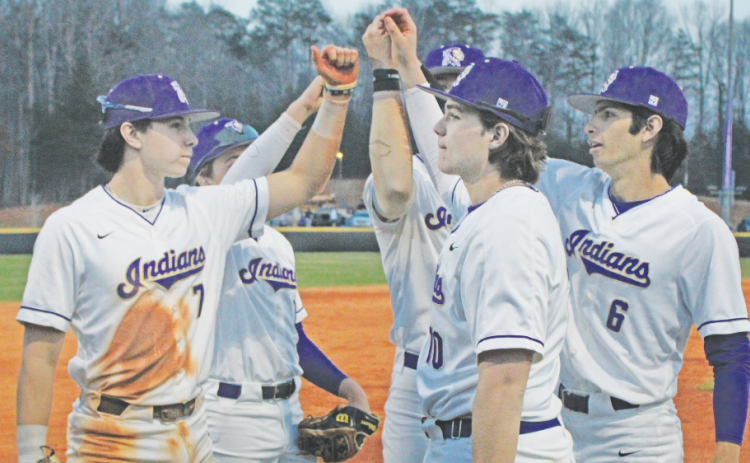 The Lumpkin County High School baseball team rallies together before storming the field against the Fannin County Rebels.