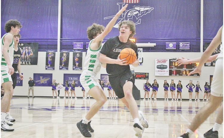Lumpkin County’s TJ Gaddis powers his way in for a layup.