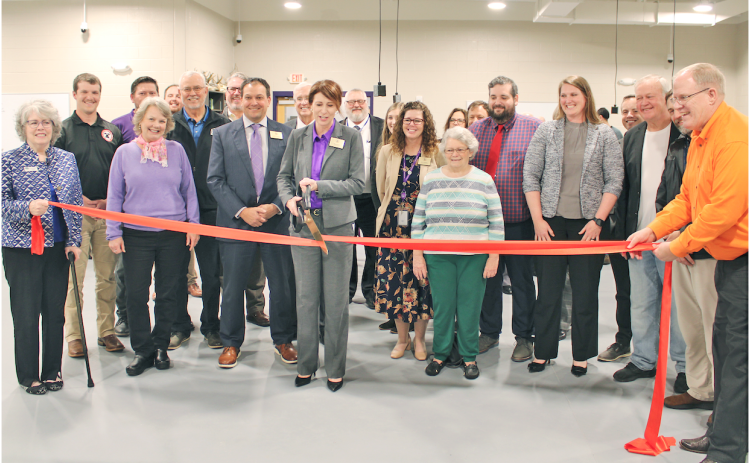 Lumpkin County Superintendent Sharon Head cuts a ceremonial ribbon in the College & Career Academy’s agricultural lab as local school board members, elected officials and project managers look on.