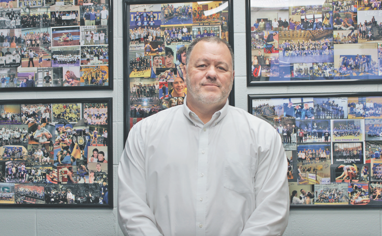 Brian Matthews has collages of photos from 15 years of coaching football hanging on the wall in his middle school office.