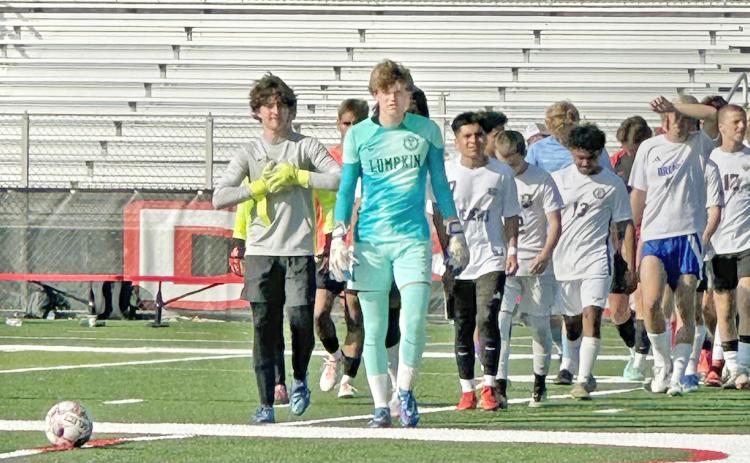Boegner leads his team onto the field in Dalton for the GACA All-State game.