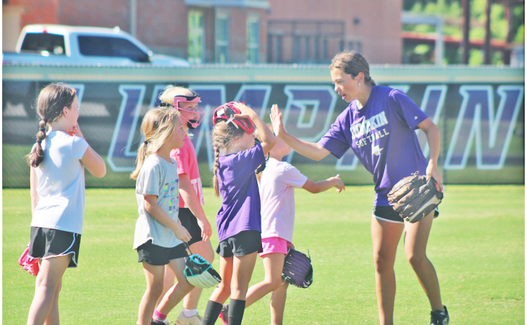 Lumpkin County player Addilaide Antonia works with the younger athletes during the softball youth summer camp.