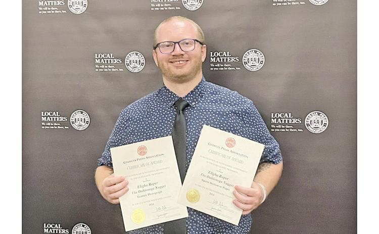 Nugget sportswriter Eligha Roper shows off new awards after the Georgia Press Association ceremony.