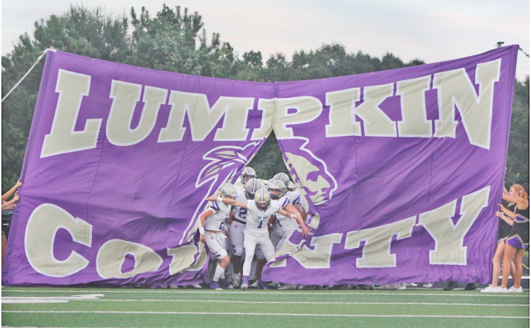 Cal Faulkner leads the Lumpkin County High School football team onto the field during a game last season.  Faulkner is looking ahead to his senior season at Lumpkin, but has already committed to Georgia Tech.