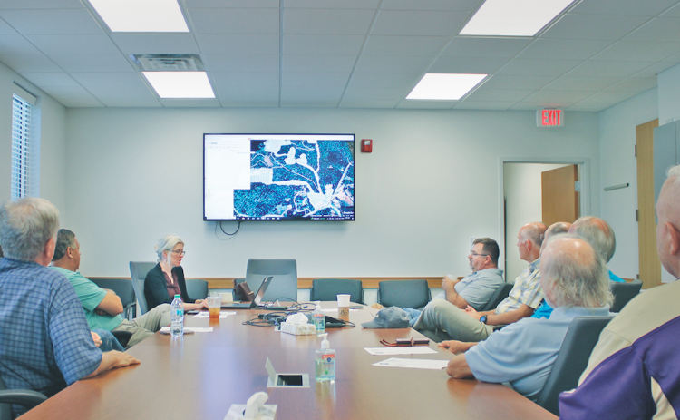 Members of the Yahoola Creek Reservoir Study Committee listen in as Planning Director Rebecca Mincey outlines the key priorities of the 2020 Reservoir Master Plan.