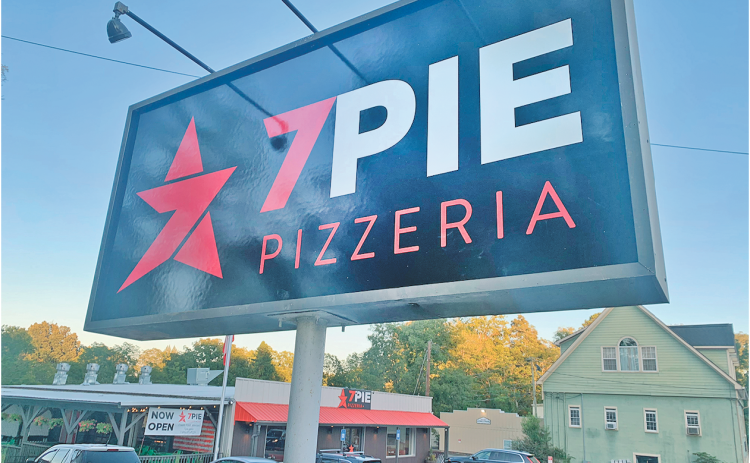 The pole-mounted sign at 7 Pie Pizzeria will remain in place after narrowly receiving approval by the Dahlonega City Council.