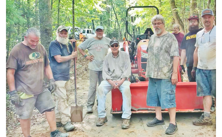 Residents living off of Syrup Mill Road pause for a quick photo during a busy day of repairs. The impromptu road crew consisted of (left to right) Don Thomas, Rick Morris, Chris Pisarik, Jack Harshbarger, Patrick Hayes, Edward Wells, Austin Hayes and Dave McDowell. Not pictured are Michell Pisarik, Lee Goff, Amanda Thomas and Fred Noble.