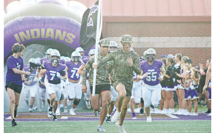 The Lumpkin County High School football team races onto the field ahead of their game against Hart County.