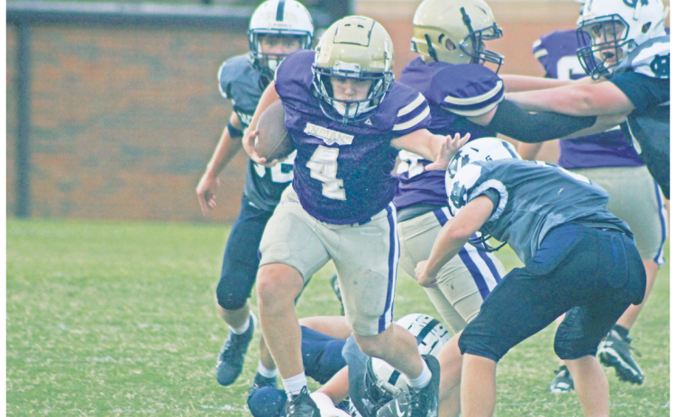 Lumpkin County’s Ben Monroe stiff-arms his way through White County defenders.