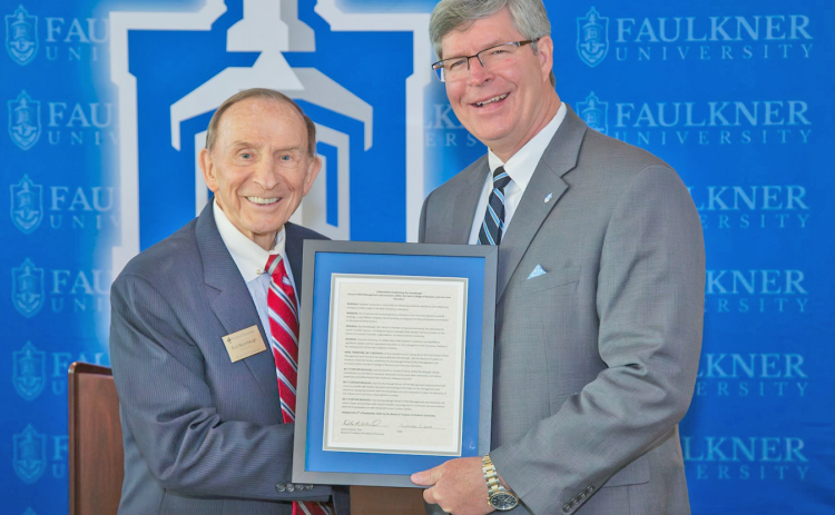 Faulkner University President Mitch Henry, right, presents local philanthropist Bud Stumbaugh with a plague commemorating the recent establishment of The Stumbaugh School of Risk Management & Insurance.