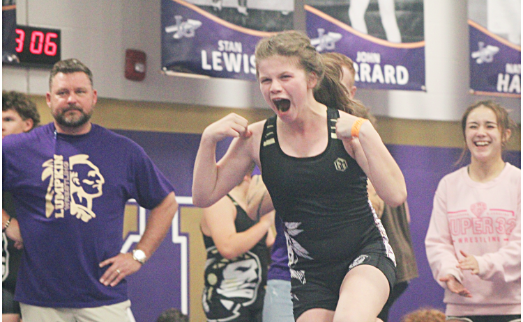 Darlene Steinberg celebrates an exhibition match victory at this week’s middle school Tri-Meet.