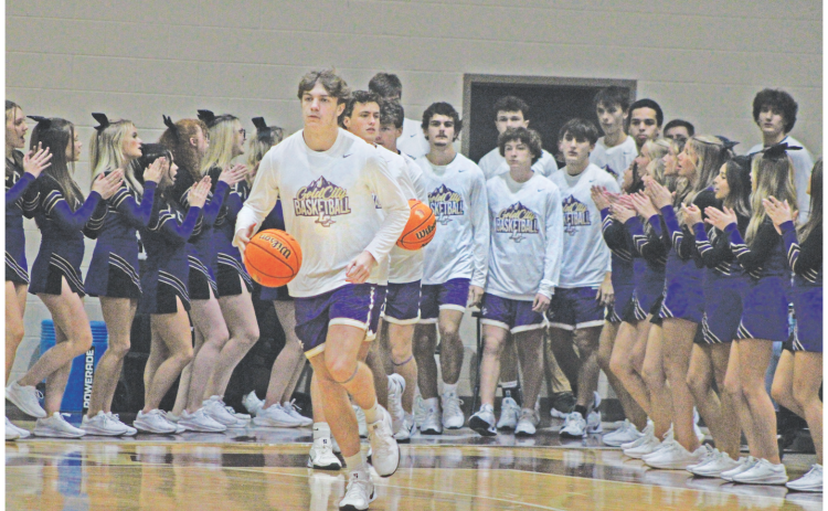 TJ Gaddis brings the team onto the court against Dawson. Gaddis led the Indians in scoring with 24 points against the Tigers.